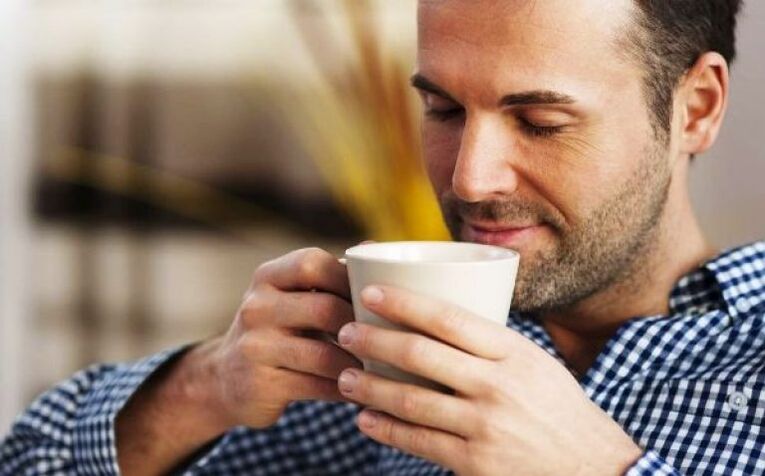 A man drinks a drink of willowherb tea to increase potency